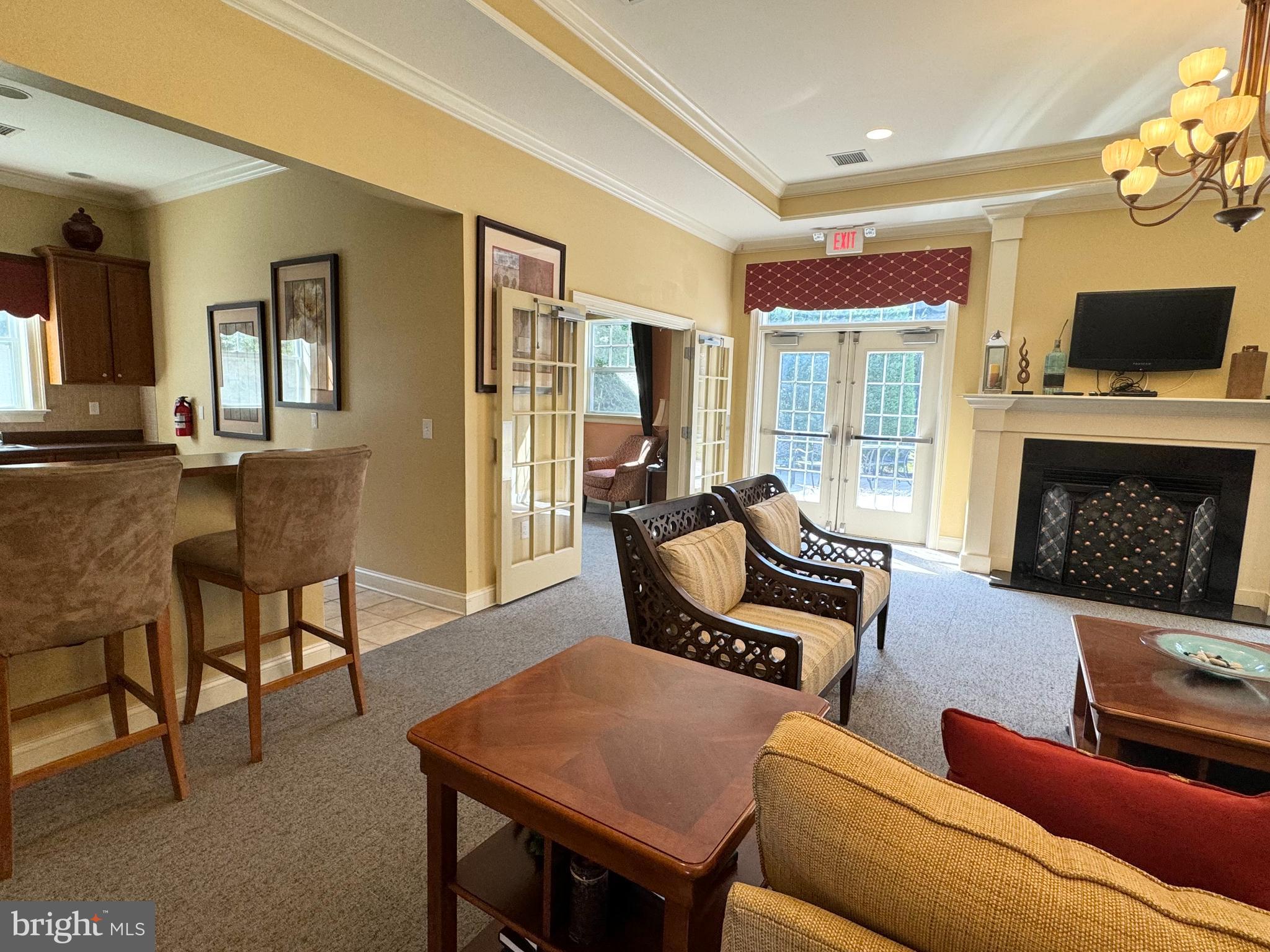 525 Timberlake Drive Ewing, NJ 08618 - Photo 16 of 27 a living room with furniture a flat screen tv and a fireplace