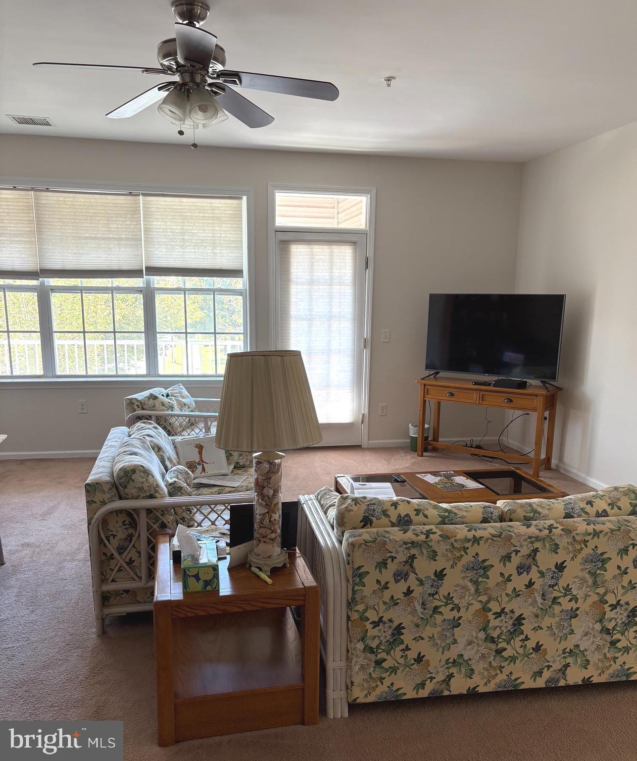 525 Timberlake Drive Ewing, NJ 08618 - Photo 2 of 27 a living room with furniture a flat screen tv and a large window