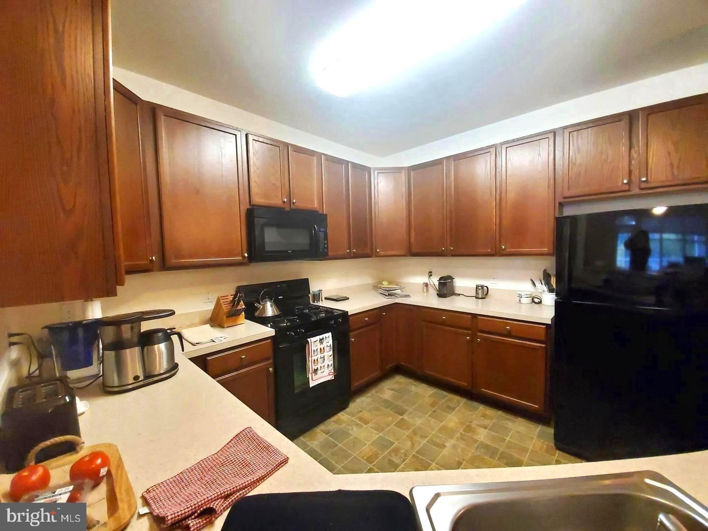 525 Timberlake Drive Ewing, NJ 08618 - Photo 8 of 27 a kitchen with stainless steel appliances granite countertop a refrigerator sink and stove