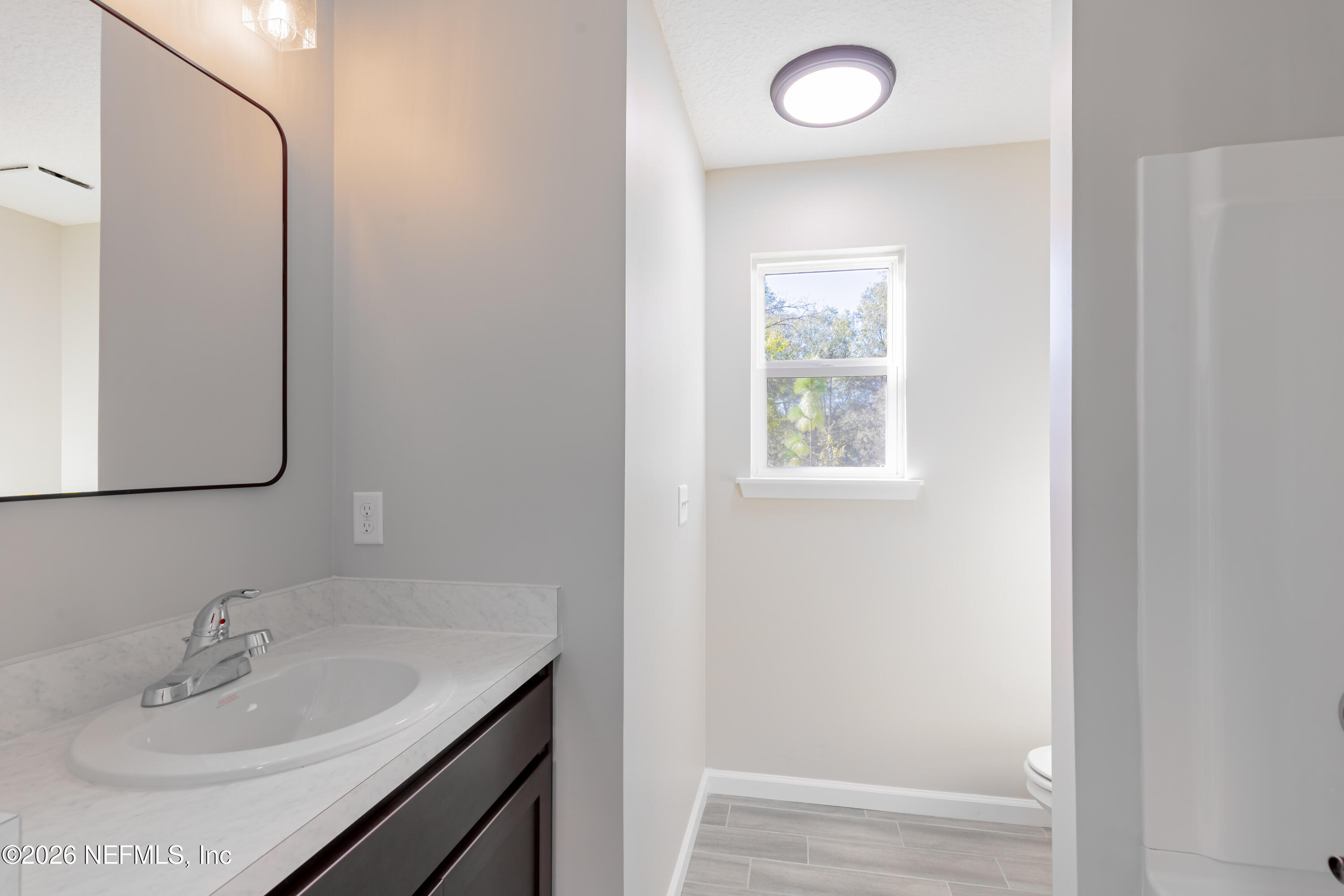 6330 Alliance Avenue Keystone Heights, FL 32656 - Photo 17 of 21 a bathroom with a sink and a mirror