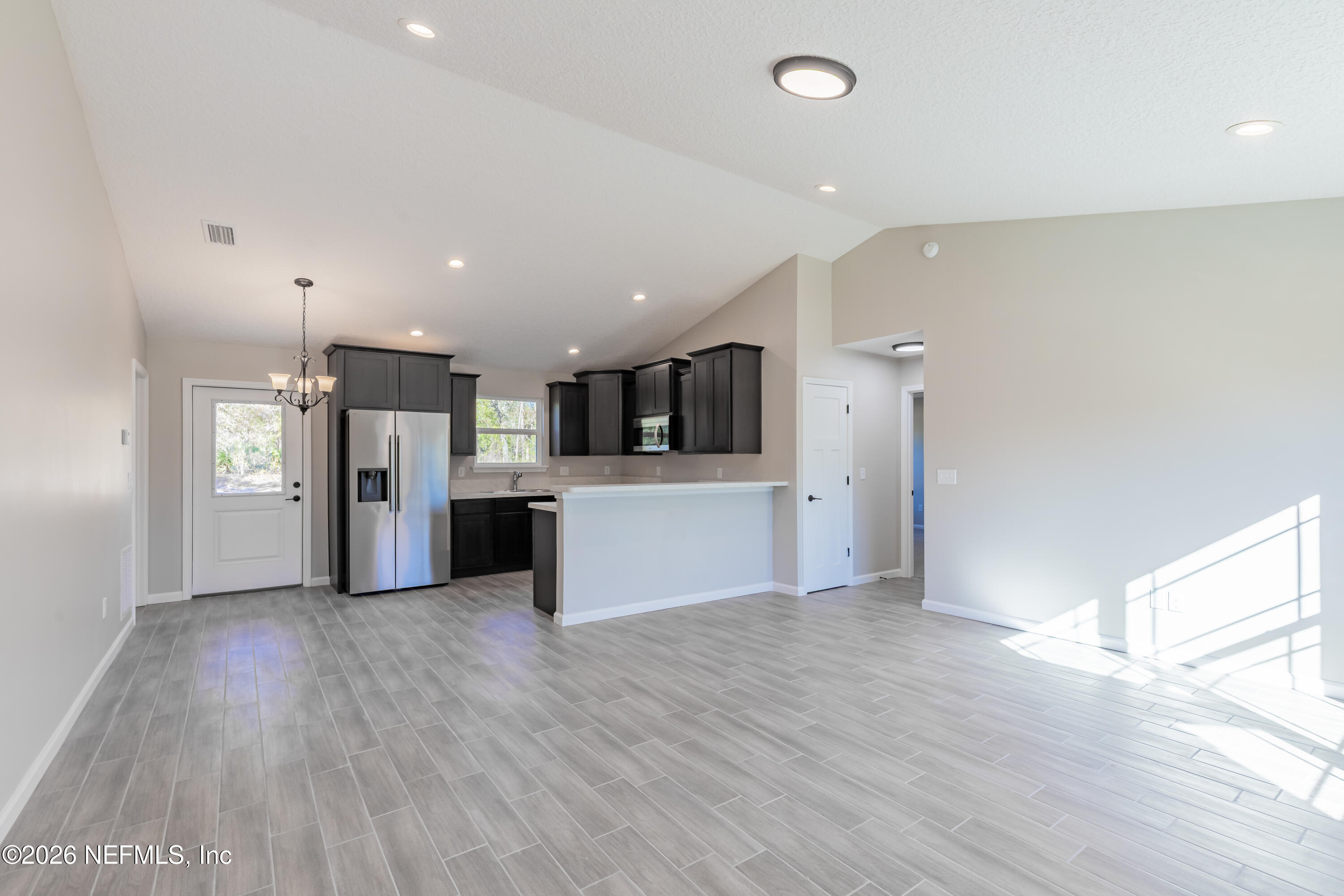 6330 Alliance Avenue Keystone Heights, FL 32656 - Photo 7 of 21 a view of a kitchen with a refrigerator and a stove top oven