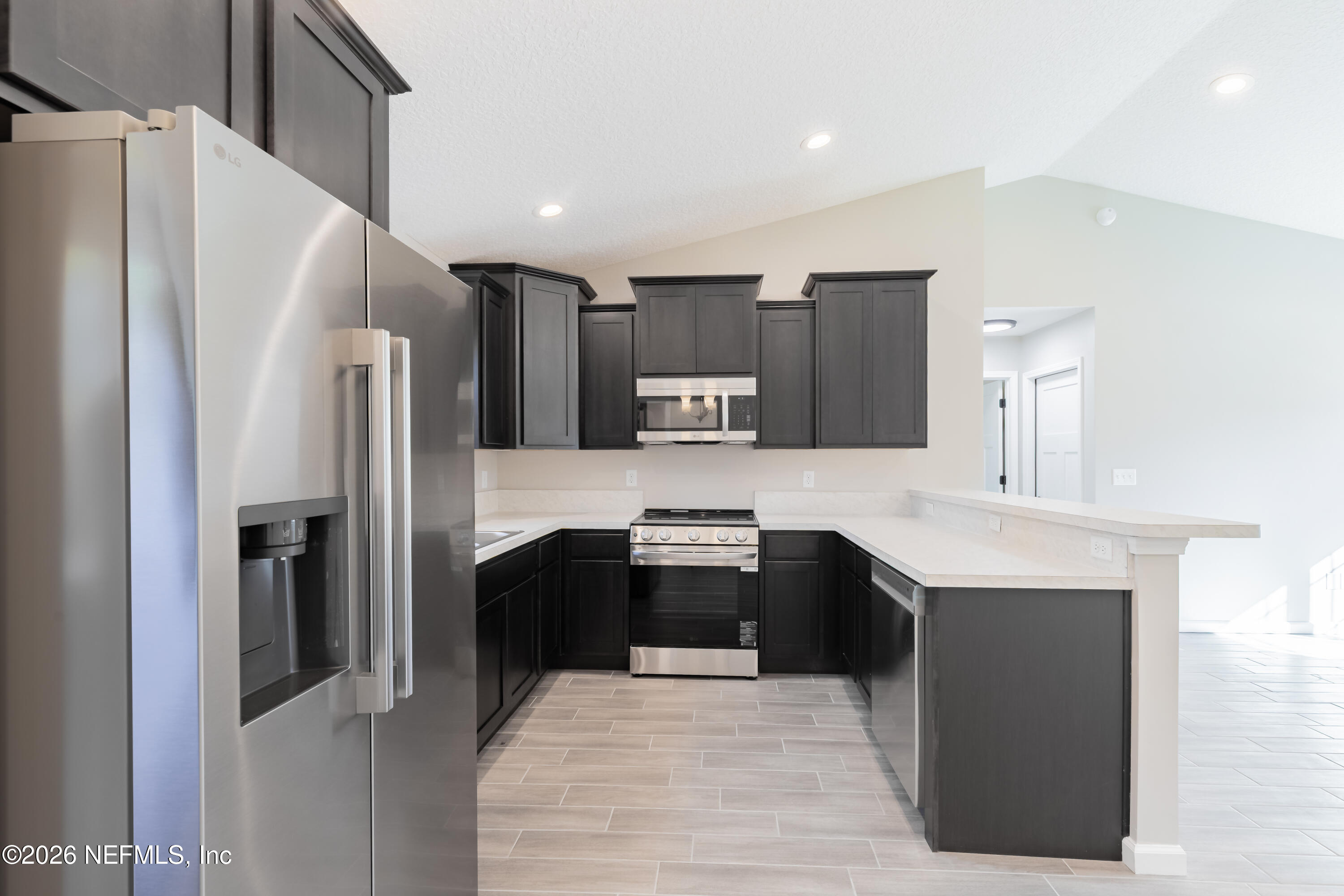6330 Alliance Avenue Keystone Heights, FL 32656 - Photo 9 of 21 a kitchen with stainless steel appliances a refrigerator sink and cabinets