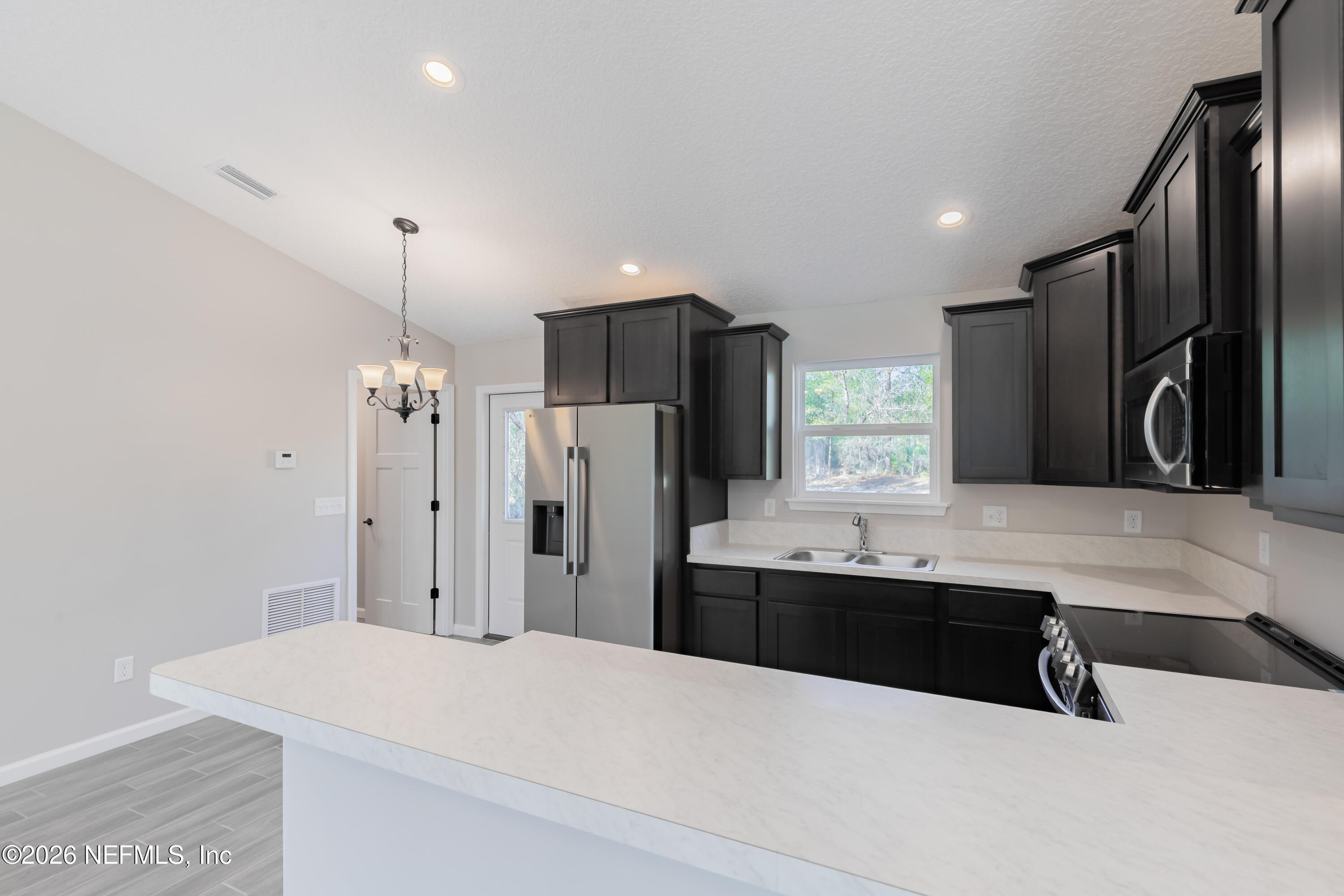 6330 Alliance Avenue Keystone Heights, FL 32656 - Photo 10 of 21 a kitchen with stainless steel appliances a sink and refrigerator