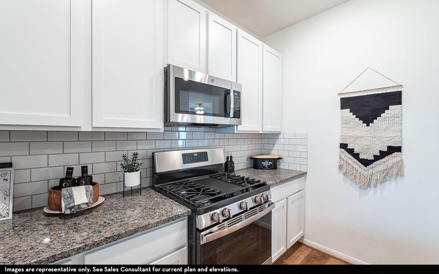418 Monarch Trail Huntsville, TX 77340 - Photo 7 of 17 a kitchen with granite countertop a stove a microwave and sink