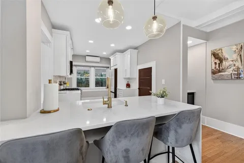 a kitchen with granite countertop a stove and a refrigerator