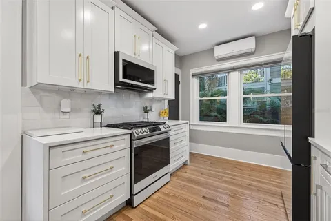 a kitchen with stainless steel appliances a stove and a microwave
