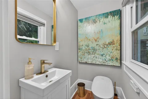 a kitchen with white cabinets and a window