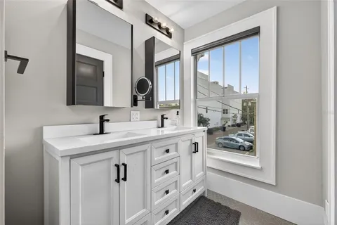a bathroom with a toilet sink and mirror