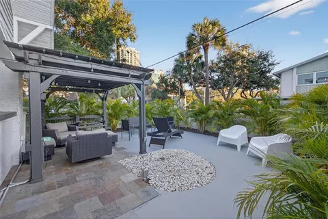 a view of a chairs and table in a backyard