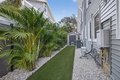 an aerial view of a house with a yard and a fountain