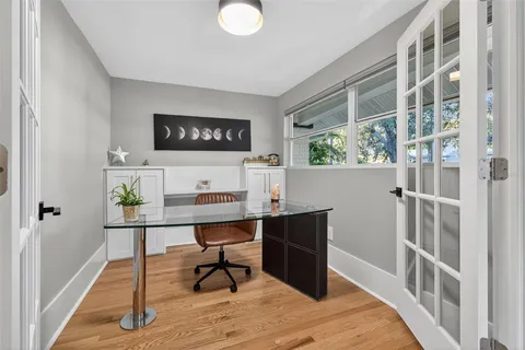 a view of a workspace with furniture and window