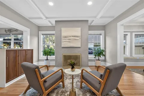 a living room with furniture and a potted plant