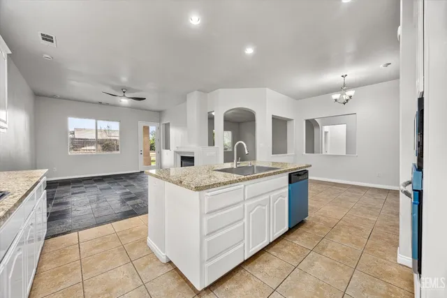 a kitchen with a sink and a stove top oven