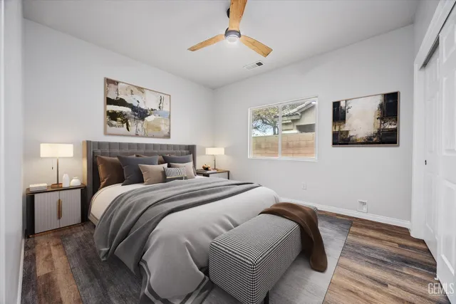 a bedroom with a bed and a painting on the wall