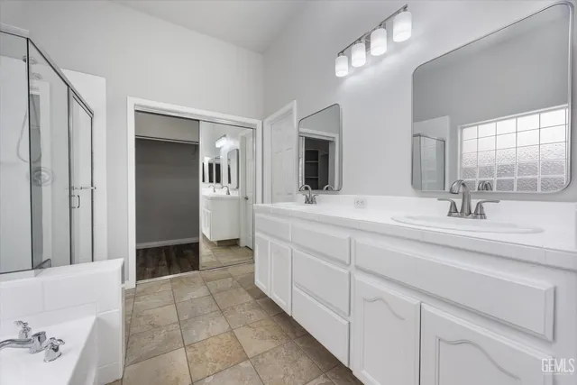 a bathroom with a double vanity sink and a mirror