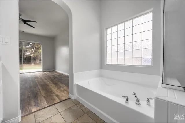 a spacious bathroom with a bathtub and window
