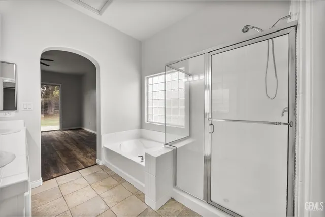 a spacious bathroom with a tub and shower