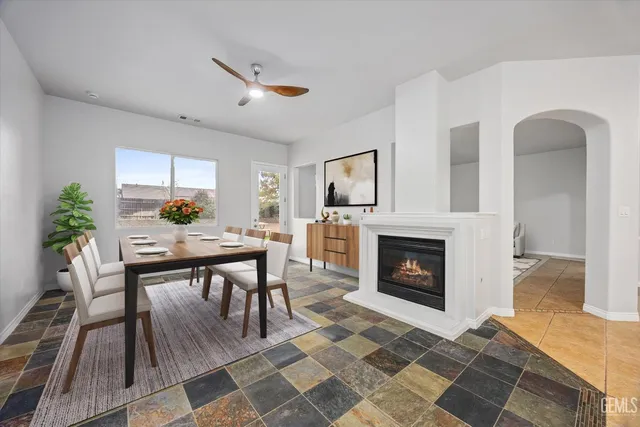 a living room with furniture a fireplace and a table