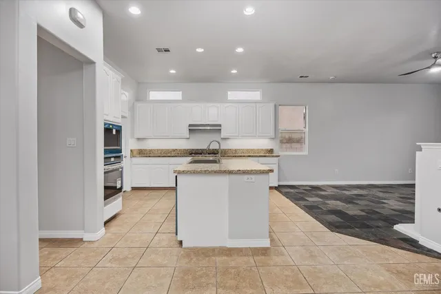 a kitchen with a sink a counter top space and appliances