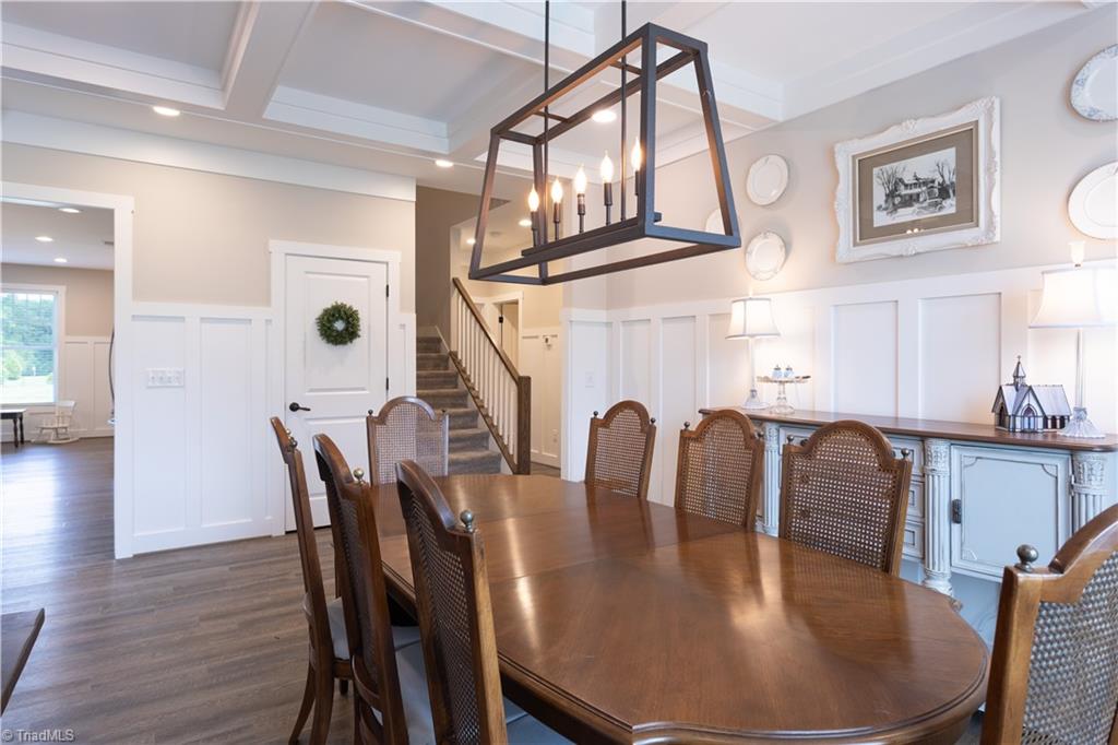 393 Scout Road Lexington, NC 27292 - Photo 21 of 47 View from inside the dining room, into the kitchen and also through to the stairwell. Over to the right of the stairs is the primary suite.