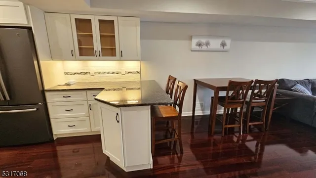 a kitchen with stainless steel appliances granite countertop a table and chairs