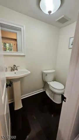 a white toilet sitting next to a bathroom sink