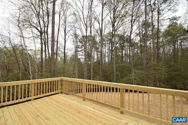 a view of balcony with wooden floor and fence