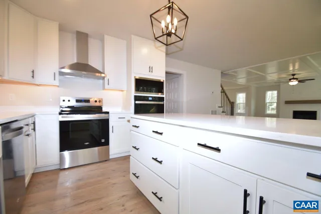 a kitchen with granite countertop a stove and a sink
