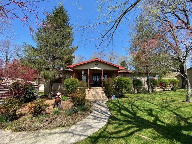 751 Monroe Floyd Road Decherd, TN 37324 - Photo 1 of 38 a front view of a house with garden