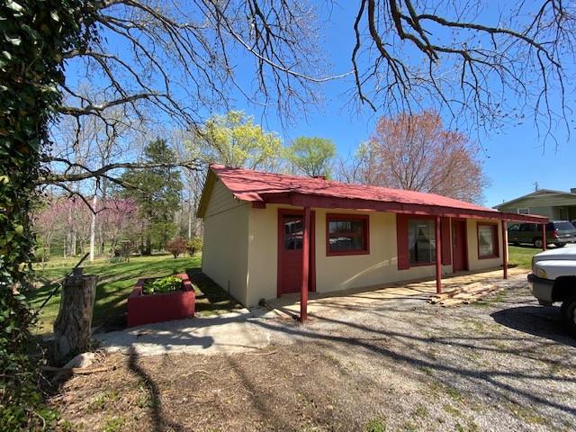 751 Monroe Floyd Road Decherd, TN 37324 - Photo 16 of 38 a view of a house with a small yard and potted plants