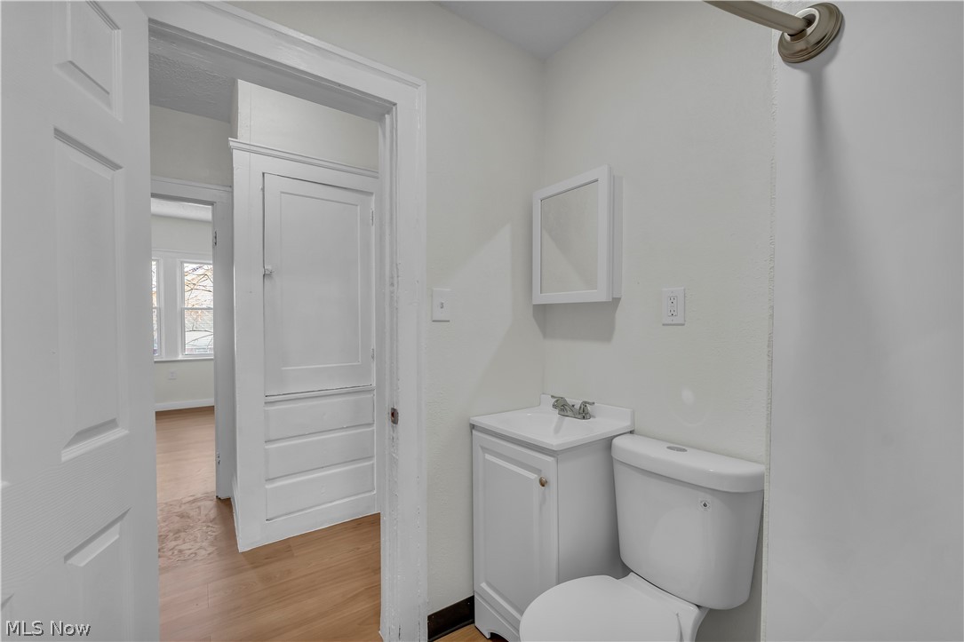 12905 Watterson Avenue Cleveland, OH 44105 - Photo 19 of 30 Half bathroom with vanity and light wood-type flooring