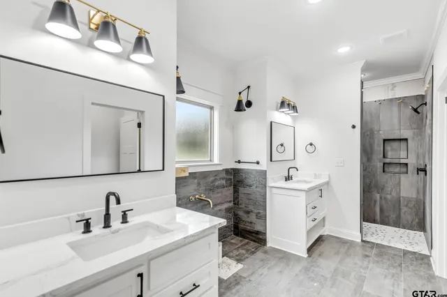 a bathroom with a double vanity sink mirror and double
