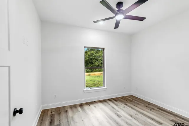a view of room with window and ceiling fan