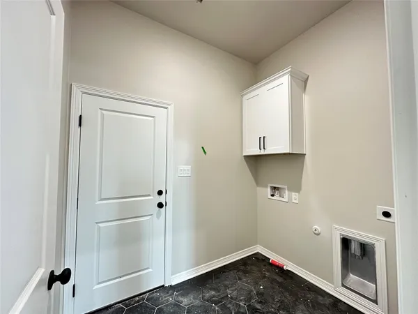 a room with a refrigerator and a sink