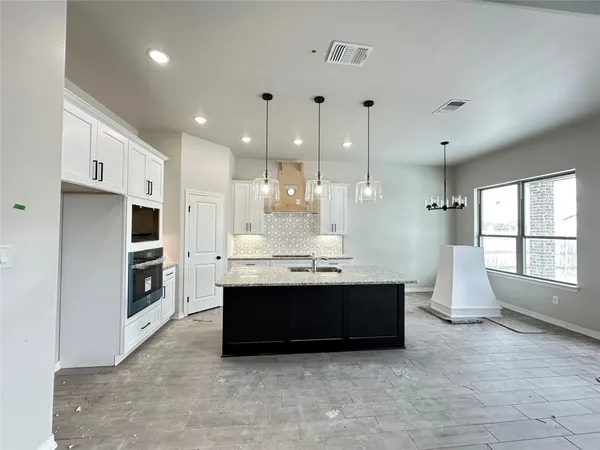 a view of kitchen with sink and cabinets