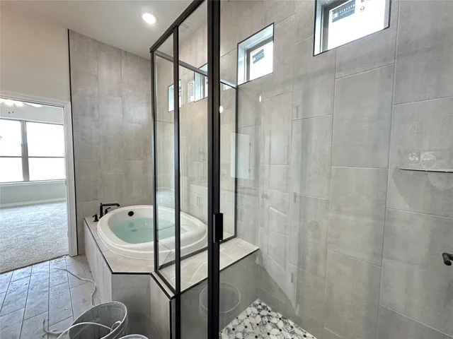 a bathroom with a tub and shower