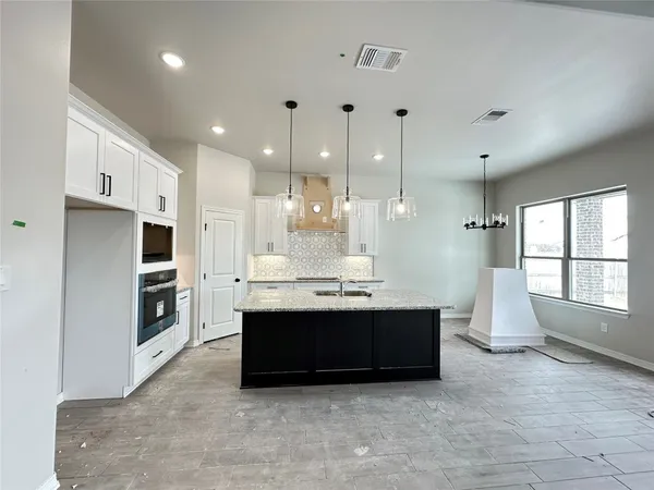 a view of kitchen with furniture and large window