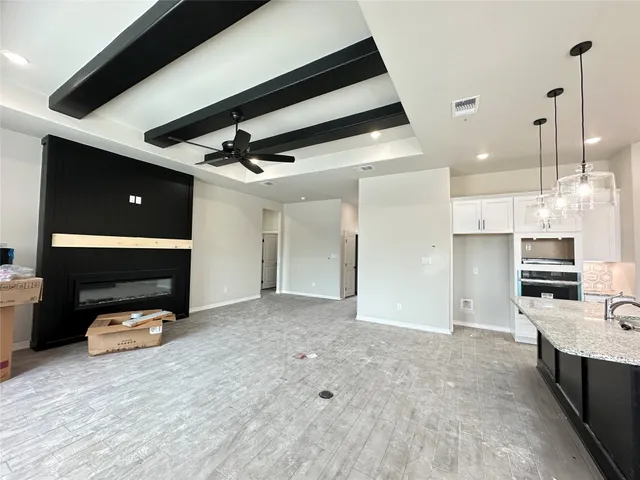 a view of a room with kitchen appliances and windows