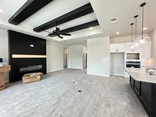 a view of a kitchen with a sink and a fireplace