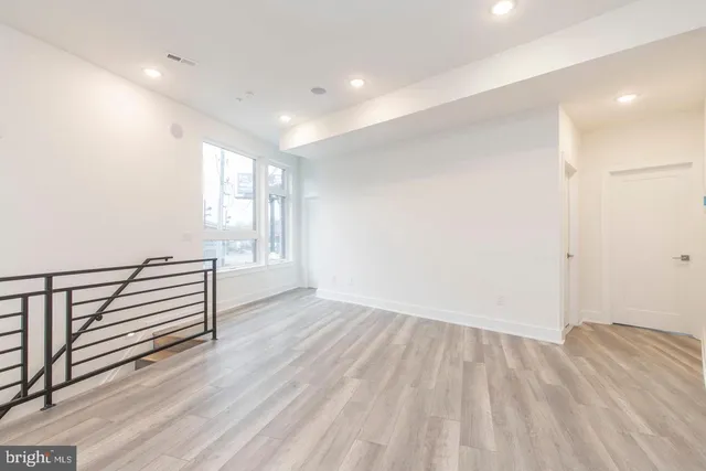 a view of a room with wooden floor and window
