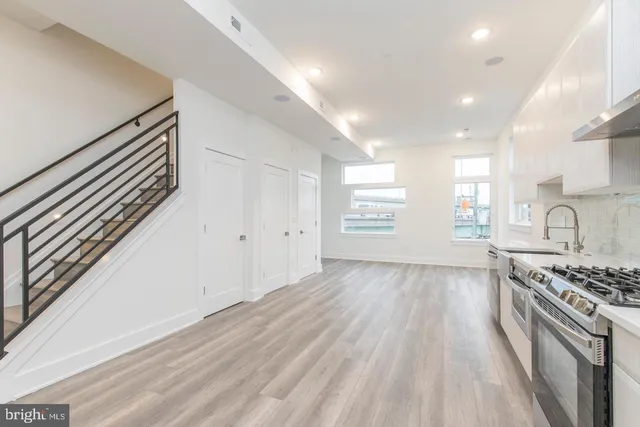a kitchen with granite countertop a stove and a sink