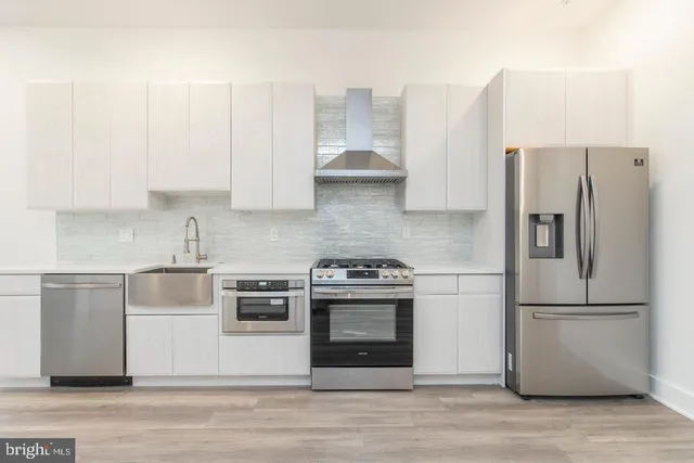 a kitchen with cabinets and stainless steel appliances
