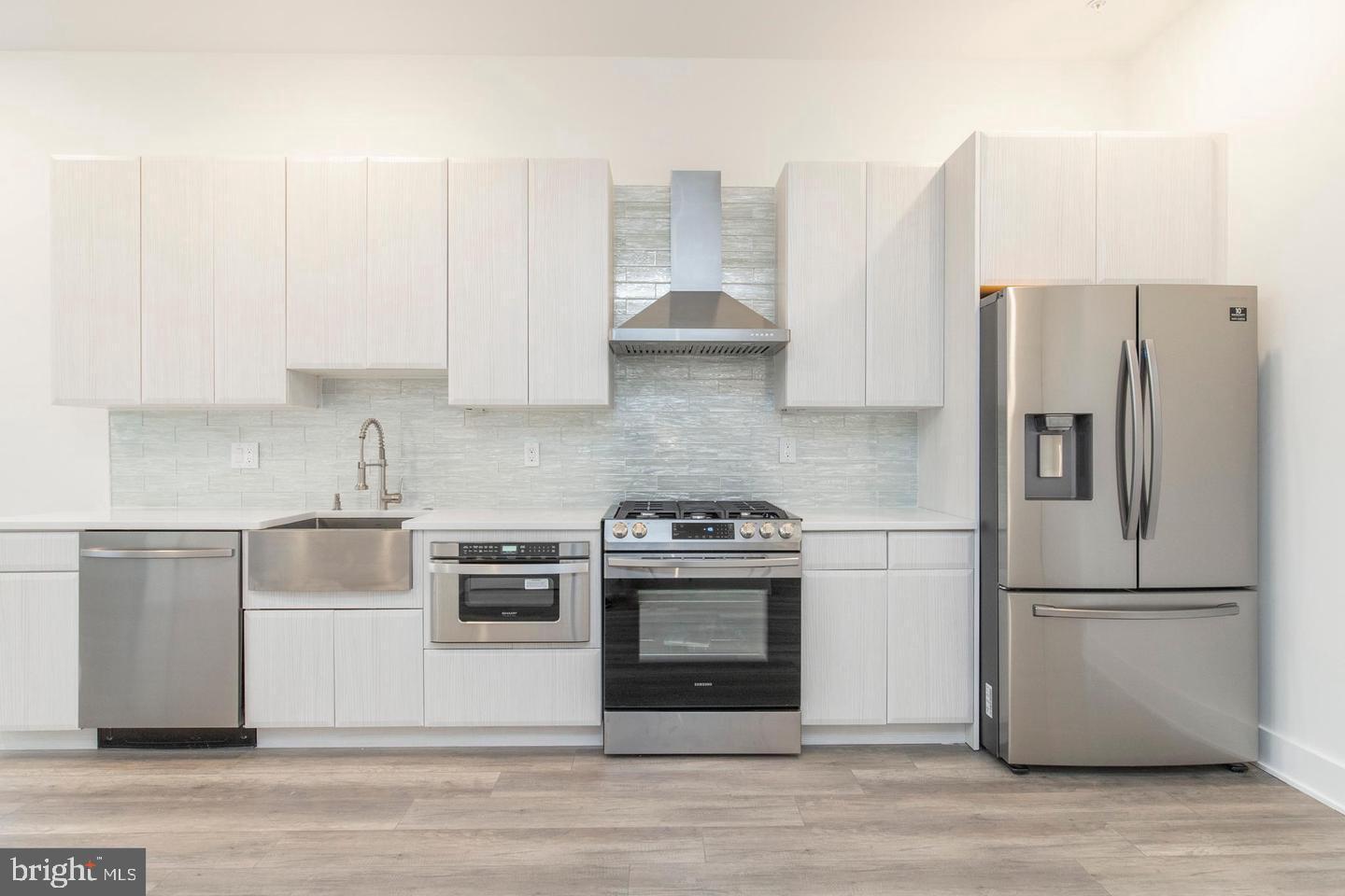 90 West Laurel Street, Unit C Philadelphia, PA 19123 - Photo 6 of 18 a kitchen with cabinets and stainless steel appliances