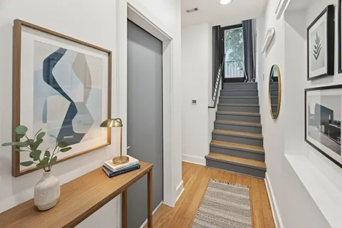 a view of a hallway with furniture and a window