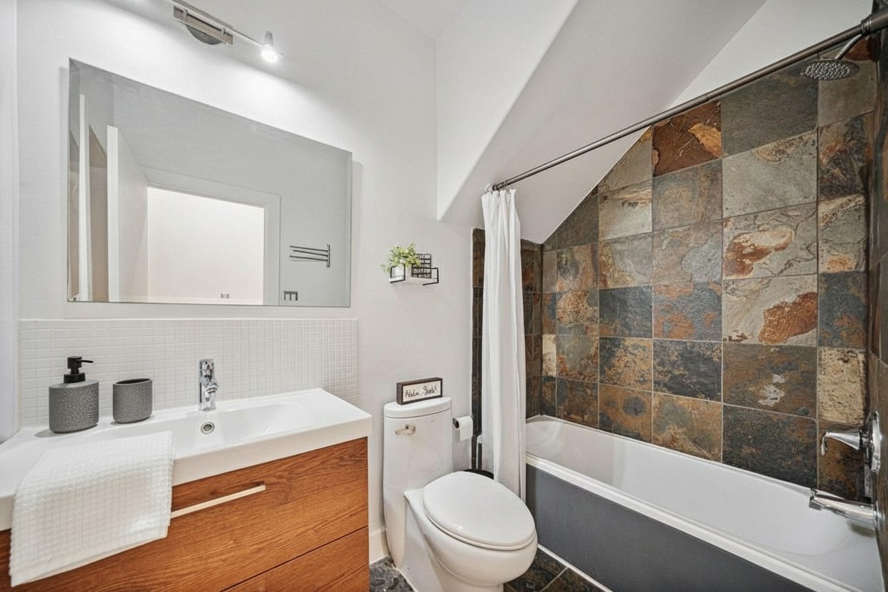 2010 Blodgett Street, Unit G Houston, TX 77004 - Photo 29 of 31 a bathroom with a bathtub shower sink vanity mirror and toilet