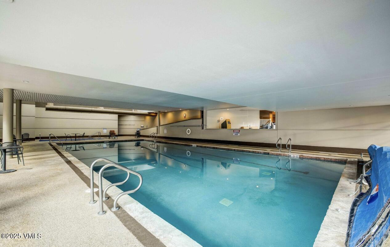 1100 North Frontage Road West, Unit 2401 Vail, CO 81657 - Photo 16 of 29 a view of a swimming pool and lounge chair