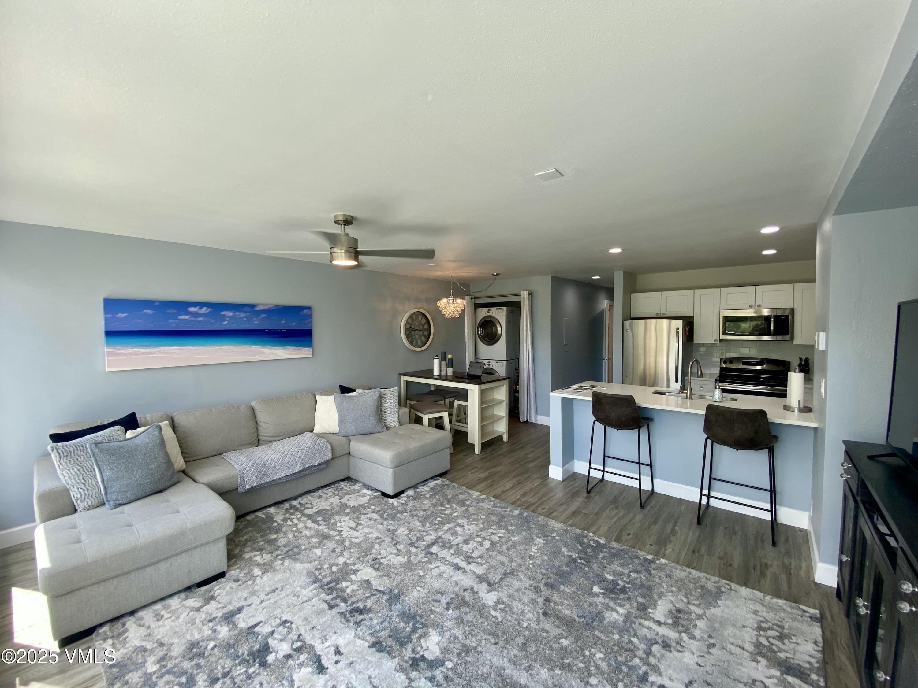 1100 North Frontage Road West, Unit 2401 Vail, CO 81657 - Photo 2 of 29 a living room with furniture and kitchen view