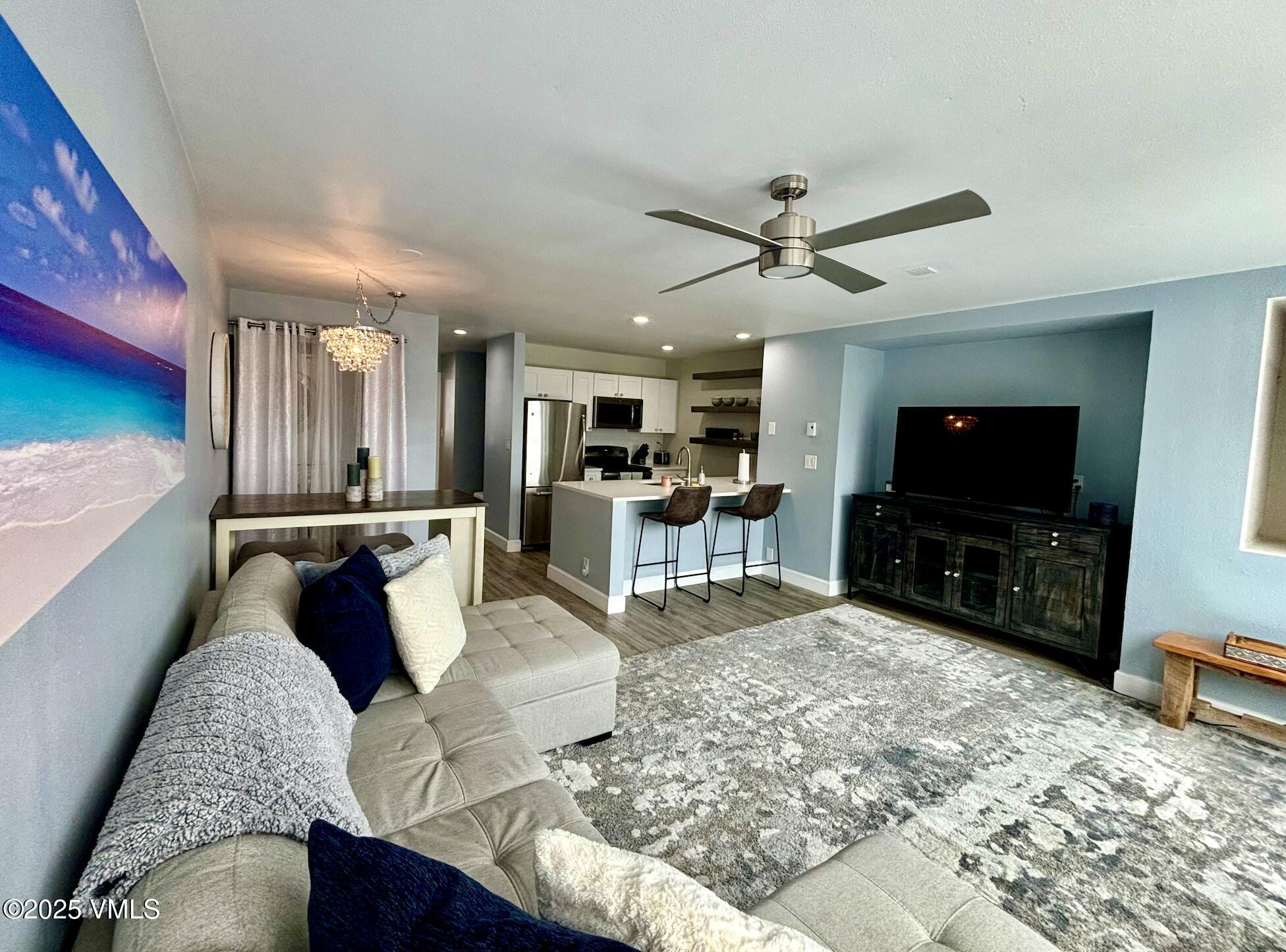 1100 North Frontage Road West, Unit 2401 Vail, CO 81657 - Photo 3 of 29 a living room with furniture and a flat screen tv