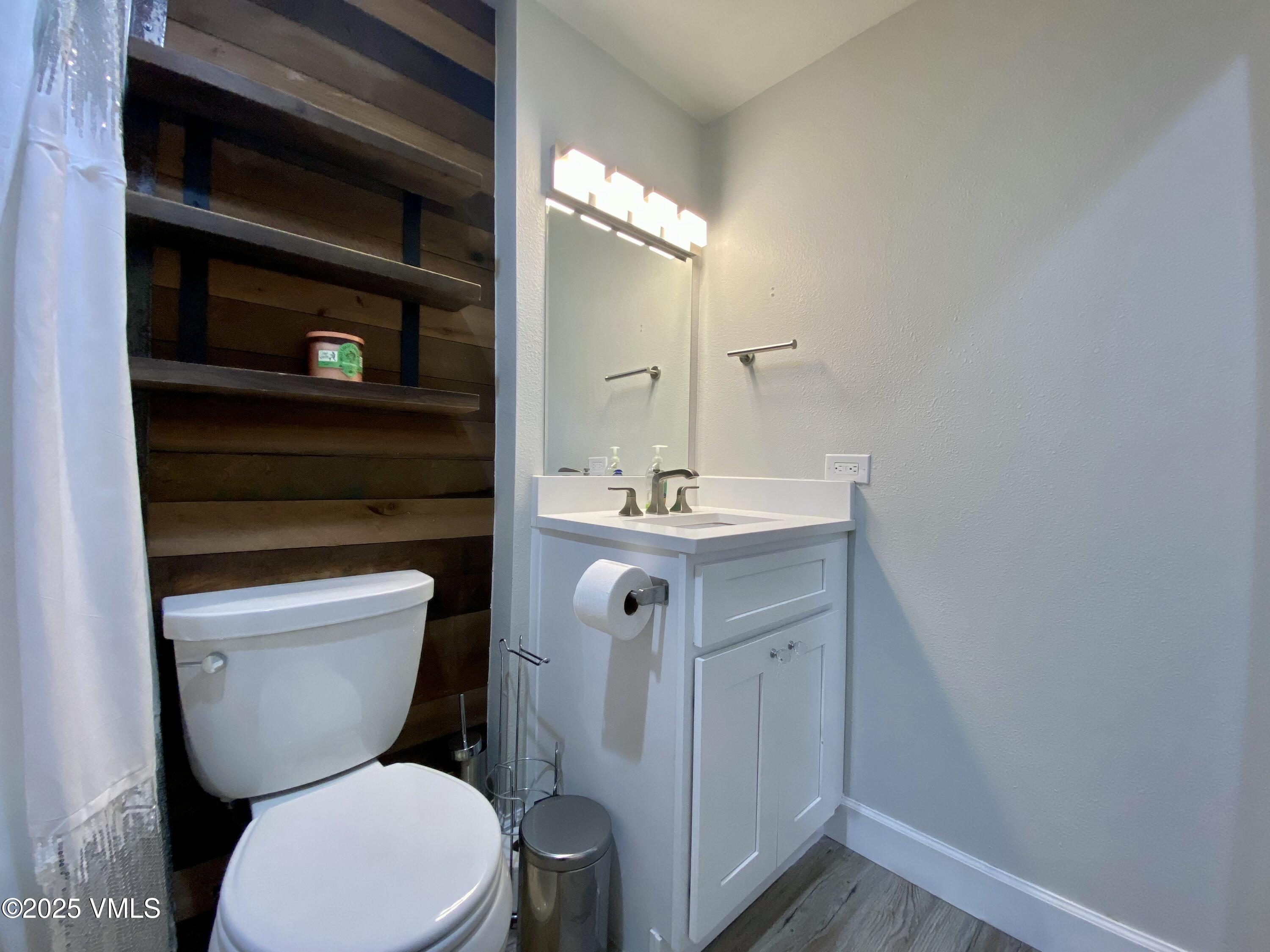 1100 North Frontage Road West, Unit 2401 Vail, CO 81657 - Photo 8 of 29 a bathroom with a toilet sink and mirror