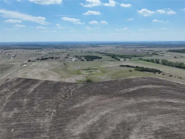 a view of dirt field with beach